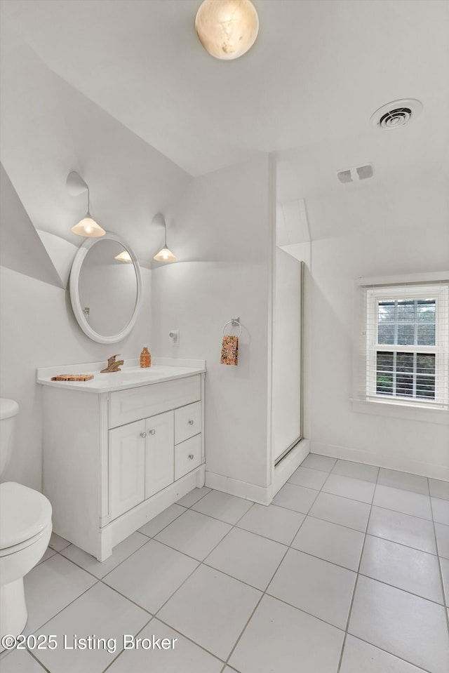 2335 Bonnycastle Ave, Louisville, KY 40205 - full bathroom featuring toilet, vanity, tile patterned floors, and vaulted ceiling