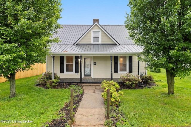 209 W High St, Lebanon, KY 40033 - farmhouse-style home with covered porch, fence, a chimney, and a front yard