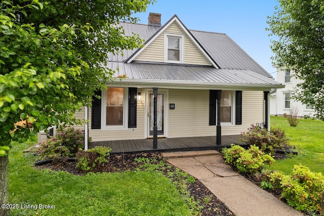 209 W High St, Lebanon, KY 40033 - bungalow-style house with a front yard, a porch, a chimney, and metal roof