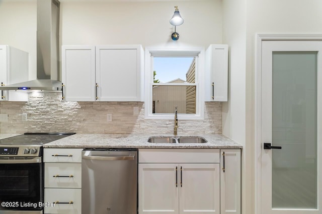 209 W High St, Lebanon, KY 40033 - kitchen with a sink, decorative backsplash, wall chimney exhaust hood, stainless steel appliances, and white cabinets