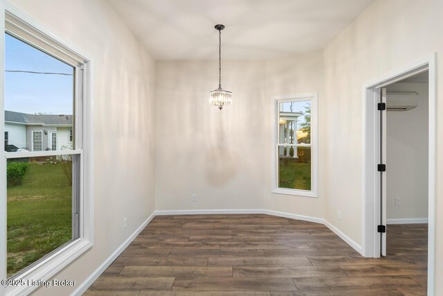 209 W High St, Lebanon, KY 40033 - unfurnished dining area with a chandelier, baseboards, plenty of natural light, and dark wood finished floors