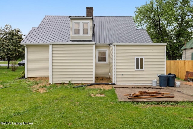 209 W High St, Lebanon, KY 40033 - back of house featuring metal roof, a chimney, and a lawn