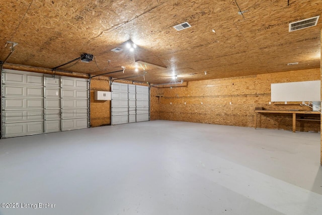 209 W High St, Lebanon, KY 40033 - garage featuring visible vents and a garage door opener
