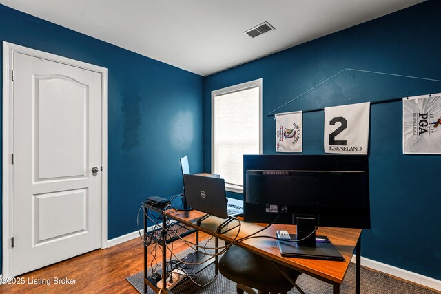 office space featuring baseboards and wood finished floors