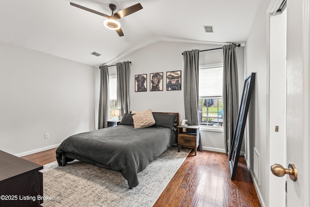 bedroom featuring lofted ceiling, dark wood-style flooring, baseboards, and ceiling fan