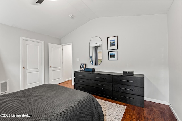 bedroom featuring vaulted ceiling, wood finished floors, and baseboards