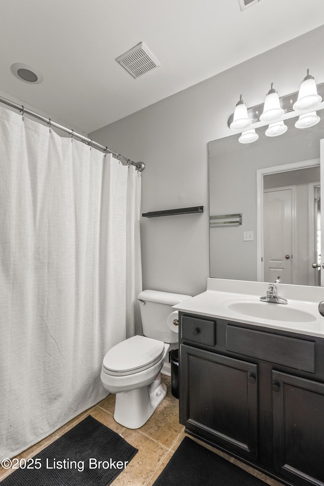 bathroom with toilet, vanity, and a shower with shower curtain