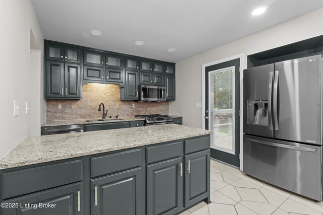 120 Emily Dr, Mt Washington, KY 40047 - kitchen with stainless steel appliances, tasteful backsplash, glass insert cabinets, light tile patterned floors, and recessed lighting