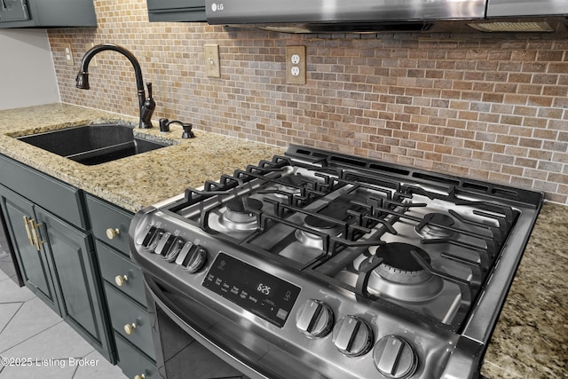 120 Emily Dr, Mt Washington, KY 40047 - kitchen view of stainless steel gas range oven, decorative backsplash, light stone counters, and gray cabinets