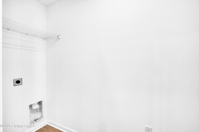 laundry room with electric dryer hookup, baseboards, laundry area, and wood finished floors