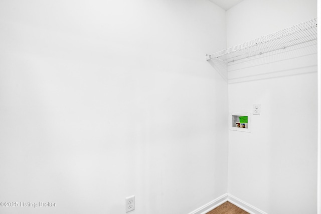 clothes washing area with laundry area, washer hookup, baseboards, and wood finished floors