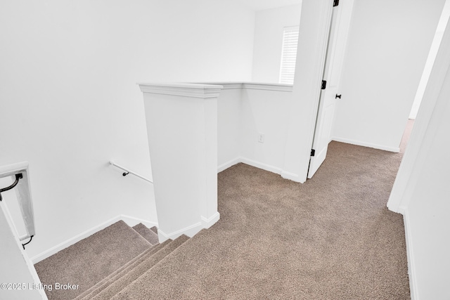interior space featuring carpet flooring and baseboards