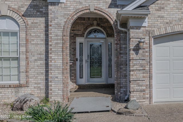 5503 Vevia Pl, Louisville, KY 40272 - doorway to property with an attached garage and brick siding