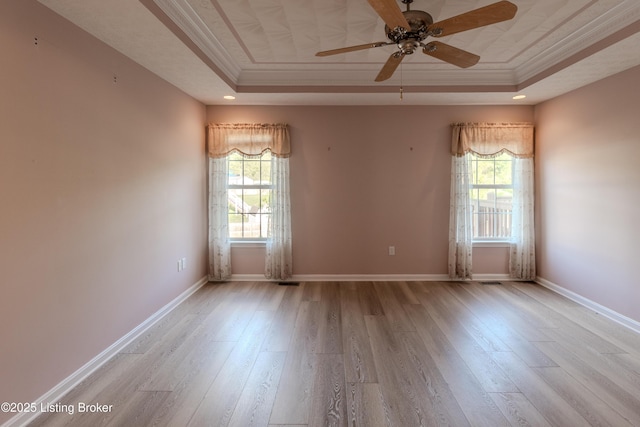 5503 Vevia Pl, Louisville, KY 40272 - unfurnished room with a raised ceiling, crown molding, healthy amount of natural light, and wood finished floors