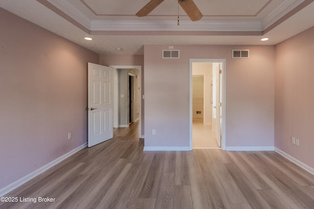5503 Vevia Pl, Louisville, KY 40272 - unfurnished bedroom featuring a tray ceiling, ornamental molding, light wood-style floors, baseboards, and recessed lighting