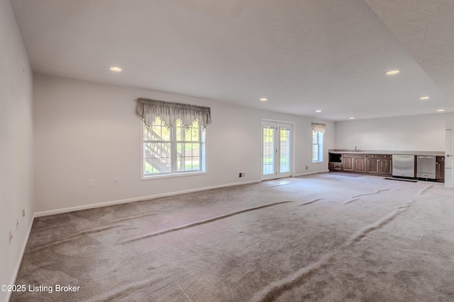 5503 Vevia Pl, Louisville, KY 40272 - unfurnished living room with recessed lighting, carpet floors, baseboards, and bar area