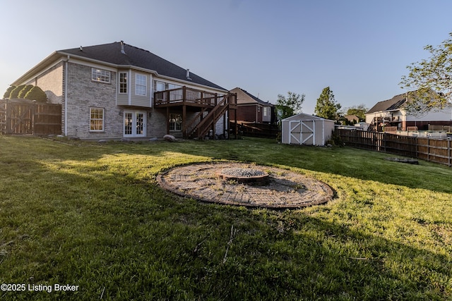 5503 Vevia Pl, Louisville, KY 40272 - back of property with a deck, a fire pit, stairway, and french doors