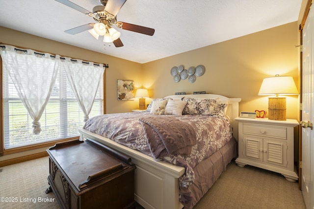 bedroom with a ceiling fan and light colored carpet