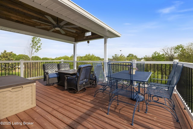 wooden deck featuring ceiling fan and outdoor dining space