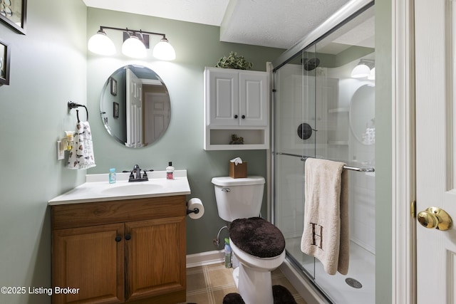 full bath featuring a stall shower, vanity, tile patterned floors, baseboards, and toilet