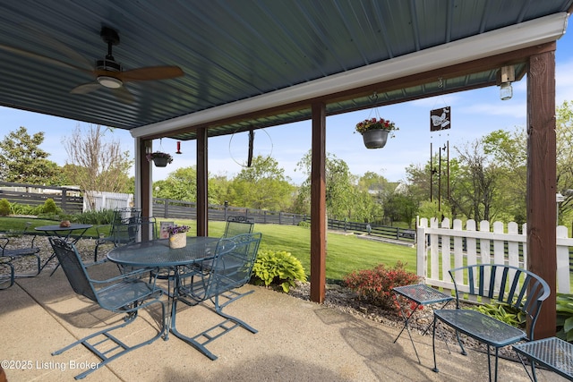 view of patio featuring outdoor dining area, a ceiling fan, and a fenced backyard