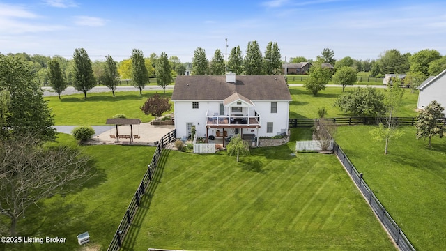 rear view of house with a yard, a patio, fence, and a wooden deck