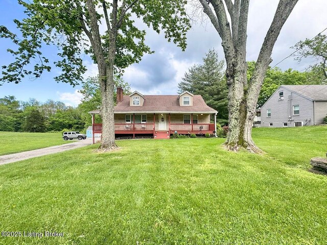 view of front of home featuring a porch, a front yard, driveway, and central air condition unit
