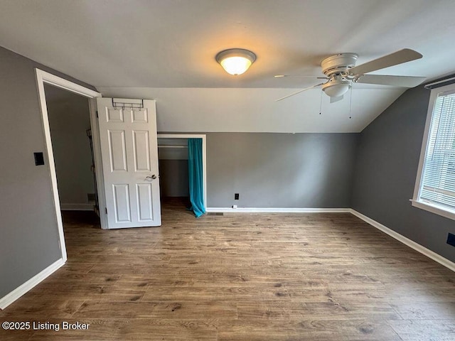 bonus room with ceiling fan, lofted ceiling, wood finished floors, and baseboards