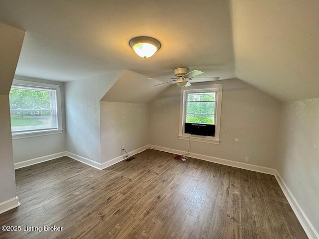 bonus room with wood finished floors, ceiling fan, baseboards, vaulted ceiling, and cooling unit