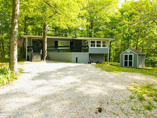 340 Cherry Pass, New Haven, KY 40051 - view of front of property featuring a shed, an outdoor structure, gravel driveway, a porch, and view of wooded area