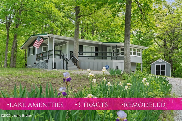 340 Cherry Pass, New Haven, KY 40051 - view of front facade featuring a shed, an outdoor structure, covered porch, stairs, and view of scattered trees