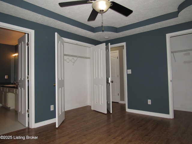 1253 Shepard Way, Shelbyville, KY 40065 - unfurnished bedroom with a textured ceiling, baseboards, a tray ceiling, and wood finished floors