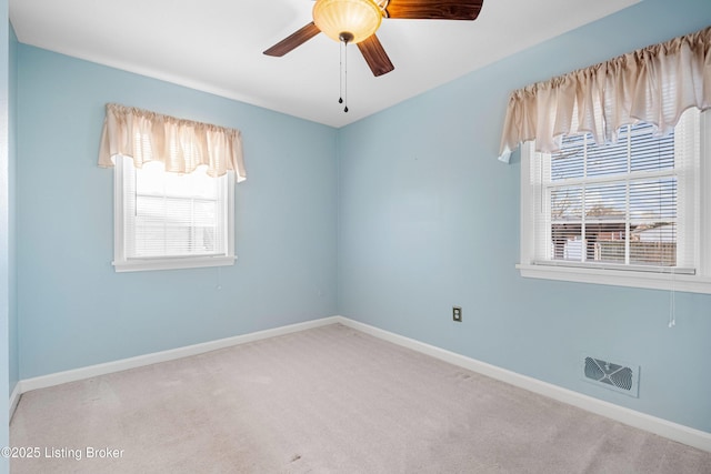 carpeted empty room with baseboards and visible vents