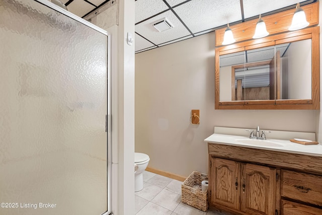 bathroom with visible vents, a shower stall, a drop ceiling, and tile patterned flooring