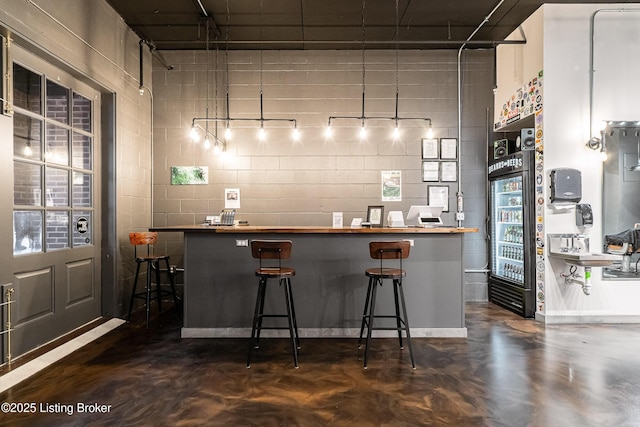 9410 Norton Comnons Blvd, Prospect, KY 40059 - indoor dry bar featuring finished concrete flooring and concrete block wall