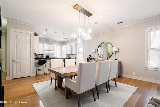 9410 Norton Comnons Blvd, Prospect, KY 40059 - dining room with crown molding, light wood-style floors, baseboards, and a chandelier