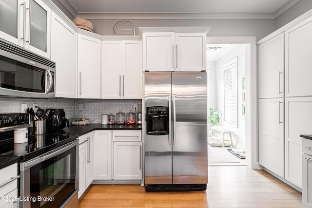 9410 Norton Comnons Blvd, Prospect, KY 40059 - kitchen featuring stainless steel appliances, dark countertops, white cabinets, and ornamental molding