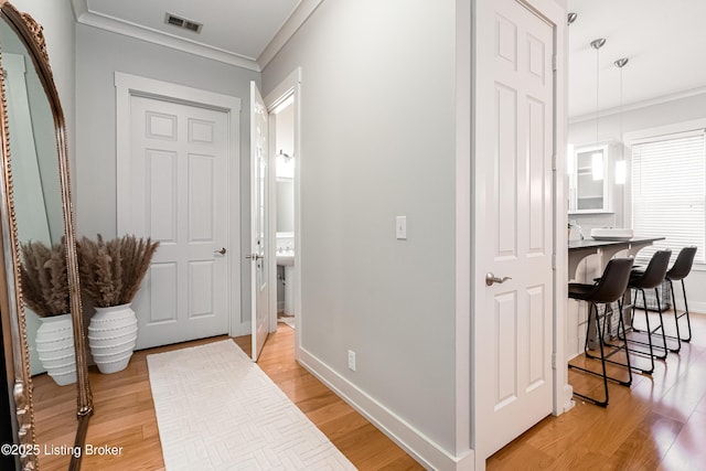 9410 Norton Comnons Blvd, Prospect, KY 40059 - hallway featuring crown molding, light wood finished floors, and baseboards