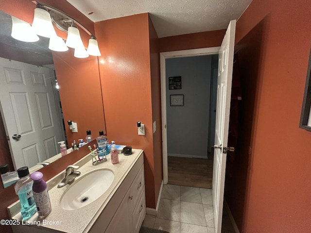 3611 Kiki Ct, Louisville, KY 40219 - bathroom featuring baseboards, a textured ceiling, tile patterned floors, and vanity