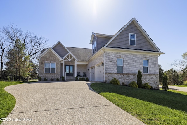 craftsman-style home with stone siding, driveway, brick siding, and a front yard