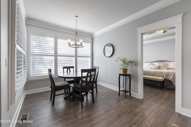 dining area with an inviting chandelier, baseboards, and ornamental molding