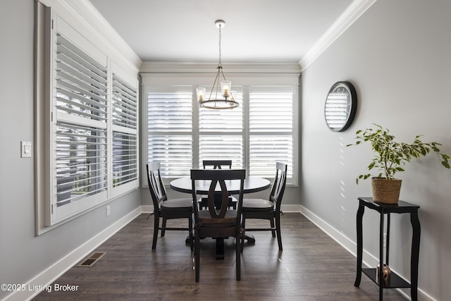 dining room featuring dark wood-style flooring, ornamental molding, baseboards, and visible vents