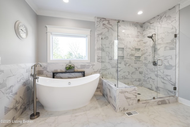 bathroom with recessed lighting, ornamental molding, visible vents, a shower stall, and a freestanding tub