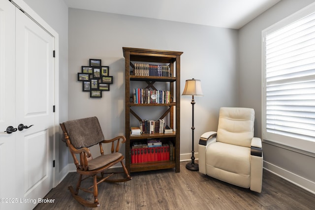 living area with baseboards and wood finished floors