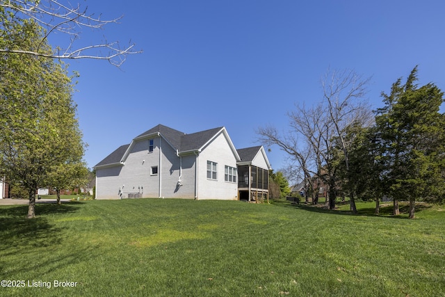 view of property exterior with a sunroom, a yard, and brick siding