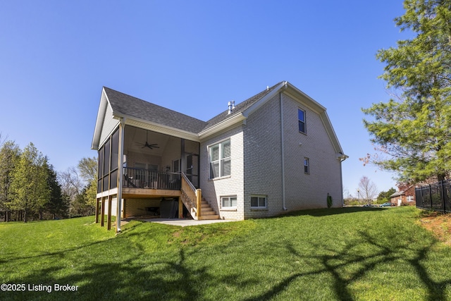 rear view of house featuring brick siding, a yard, stairway, ceiling fan, and a wooden deck