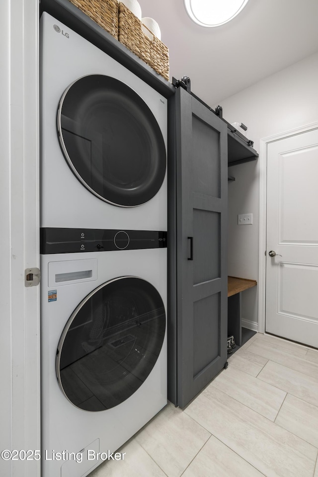 9102 Pinnacle Place Dr, Louisville, KY 40272 - laundry area featuring stacked washing machine and dryer and light tile patterned flooring