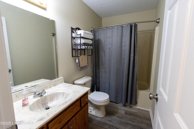 full bath featuring a textured ceiling, toilet, vanity, shower / bathtub combination with curtain, and wood finished floors