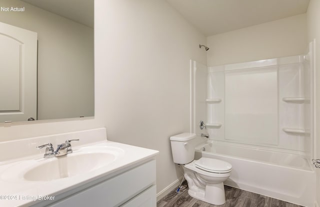 full bath featuring vanity, tub / shower combination, wood finished floors, toilet, and baseboards