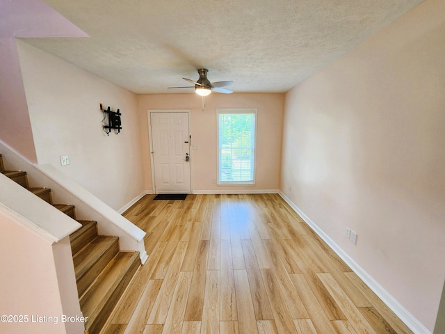 611 Malcolm Ave, Louisville, KY 40223 - foyer with ceiling fan, light wood-style floors, stairs, and a textured ceiling